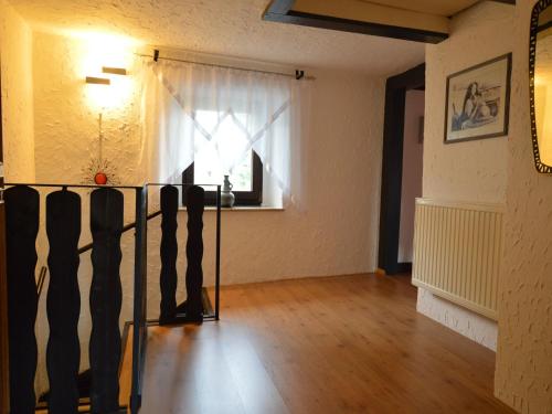 a living room with a window and a wooden floor at Rühlen Schneifel Escape in Auw