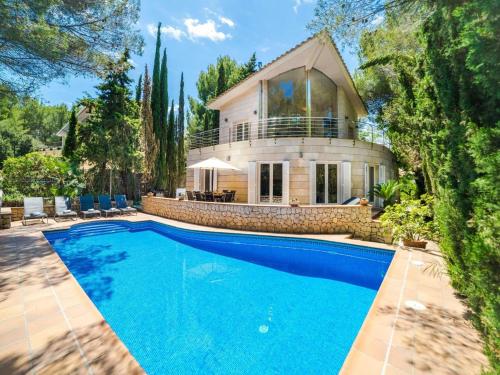 a home with a swimming pool in front of a house at Villa in Alcúdia near Sandy Beach in Alcudia