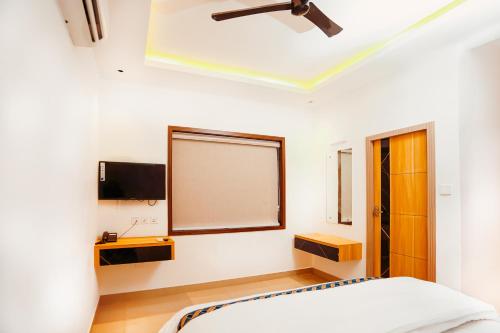 a bedroom with a bed and a large window at Dubai Frame Residency And Hotel in Thottada