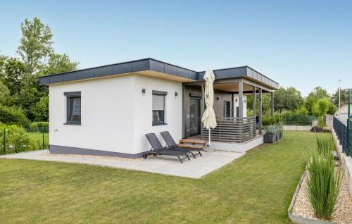 a small white house with a black roof at 2 Bedroom Nice Home In Kirchfidisch in Kirchfidisch