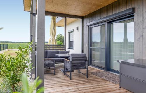 a patio with a table and chairs on a deck at 2 Bedroom Nice Home In Kirchfidisch in Kirchfidisch