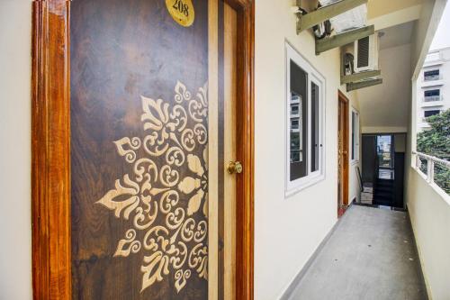 a wooden door with a gold design on it at Super Hotel O EMBASSYINN in Kondapur