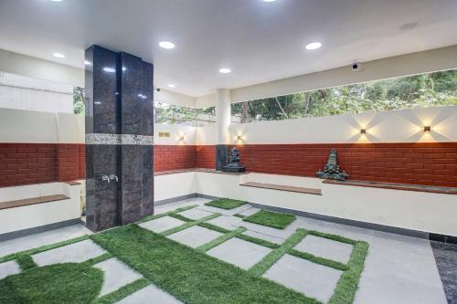 a bathroom with grass on the floor at Super Hotel O EMBASSYINN in Kondapur