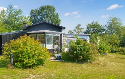 a small house with a window in a yard at Awesome Home In Mesinge With Wifi in Mesinge