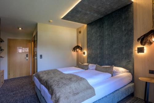 Hotel Jägerhof Mayrhofenにあるベッド