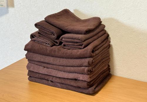 a pile of towels sitting on top of a table at Cozy Apartment, 2min to Station , Direct to Skytree, Asakusa & Ueno & Narita ,駅2分,スカイツリー浅草上野成田空港直結,エレベーター,スーパー2分,コンビニ1分 in Tokyo