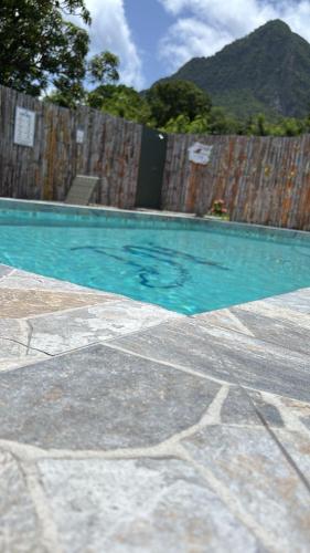 a swimming pool next to a wooden fence at Desired View vacation rentals in LʼIvrogne