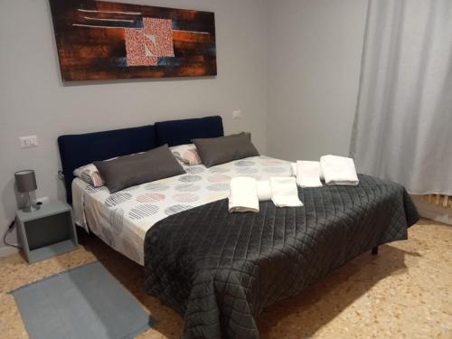 a bedroom with a bed with white towels on it at La Casa di Paola in Graffignano