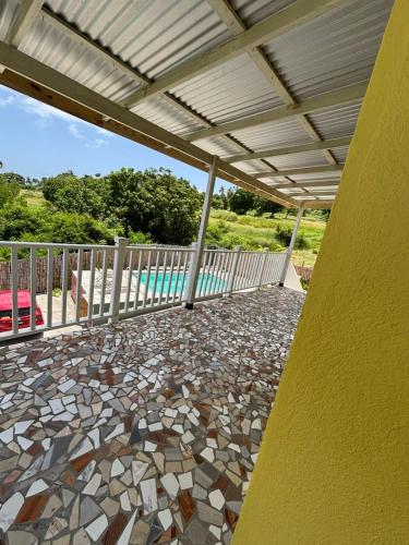 a patio with a stone floor and a white railing at Desired View vacation rentals in LʼIvrogne