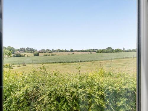 a view of a field from a window at Butler's Barn in Darsham