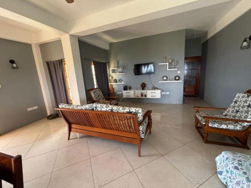 a living room with two couches and a tv at Desired View in Choiseul