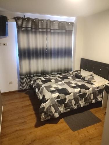 a bedroom with a bed in front of a window at Hermoso Monoambiente in Cochabamba