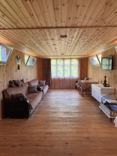 a living room with a couch and a table at In the Forest in K'vemo Jocho