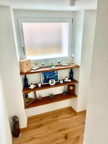 a window in a room with wooden shelves at LoSteLaDa sul lago di Como in Colico