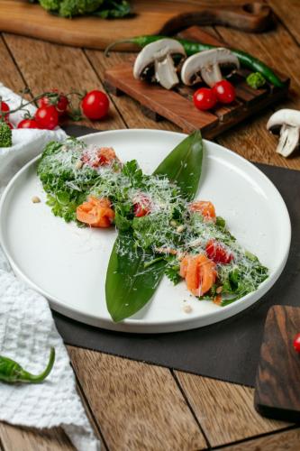 a white plate of food on a wooden table at Sweet Baku Hostel in Baku