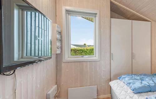 a small room with a bed and a window at Holiday Home Chr Jacobsensvej in Årøsund