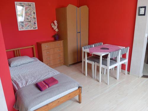 a bedroom with a bed and a table and chair at Marianki in Dąbrowa Górnicza