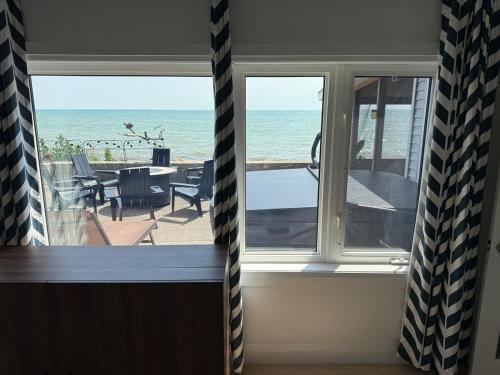 a room with a view of the beach from a window at E&S Lake House Retreate & S Lake House Retreat in Amherstburg