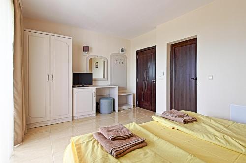 a bedroom with a bed with towels on it at White House in Ognyanovo