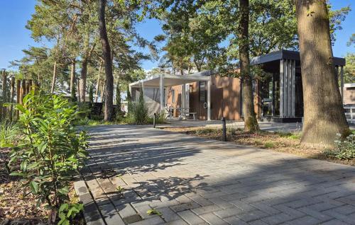 a house in a forest with a walkway at 2 Bedroom Gorgeous Home In Hellendoorn in Hellendoorn