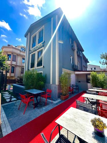 a building with tables and chairs on a red rug at Casa Florya Travel Apartments in Istanbul