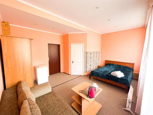 a living room with a bed and a couch at Шешори Еко in Sheshory