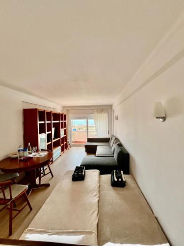 a living room with a couch and a table at Lisbon Beach Flat- Costa Caparica in Costa da Caparica