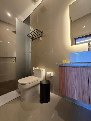 a bathroom with a toilet and a sink at The Polle Canggu in Badung