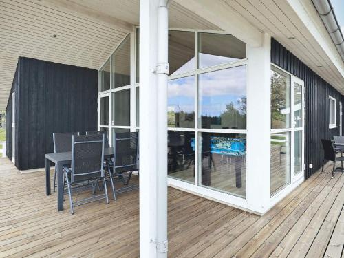 a patio with a table and chairs on a deck at 6 person holiday home in Fjerritslev-By Traum in Fjerritslev