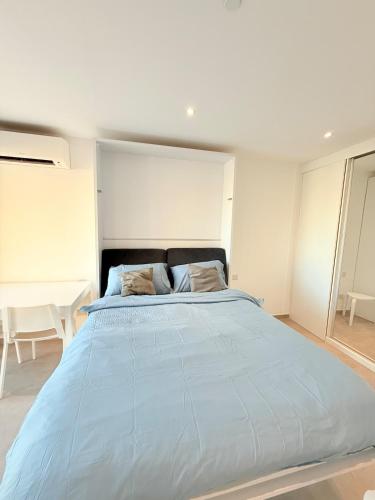 a bedroom with a large blue bed in it at E1 Simple Apartment in Gibraltar