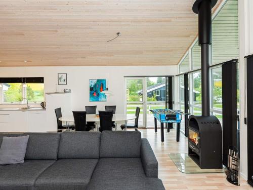 a living room with a couch and a fireplace at 6 person holiday home in Fjerritslev-By Traum in Fjerritslev