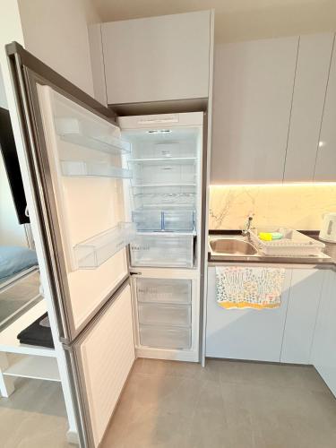 an empty refrigerator with its door open in a kitchen at E1 Simple Apartment in Gibraltar
