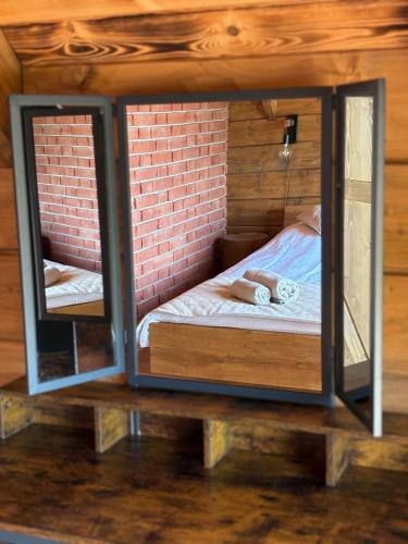 a small room with a bed inside of it at Stodoła na Drobnym Wierchu in Podwilk