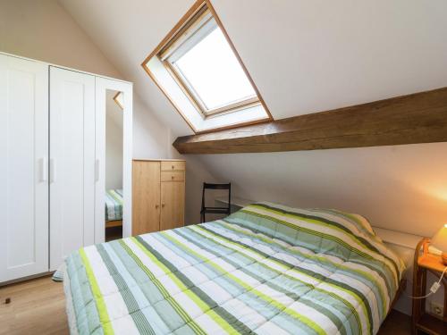 a bedroom with a bed and a skylight at Peaceful Fontenelle Farmhouse in Walcourt