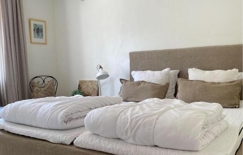 two large white pillows sitting on top of a bed at 2 Bedroom Amazing Home In Kivik in Kivik
