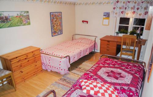 a bedroom with a bed and a dresser and a table at Three-Bedroom Holiday Home Brösarp With A Fireplace 05 in Brösarp