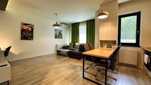 a living room with a table and a couch at Timisoara Prime Residence - powered by NEO - private parking in Timişoara