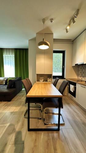 a kitchen and dining room with a table and chairs at Timisoara Prime Residence - powered by NEO - private parking in Timişoara