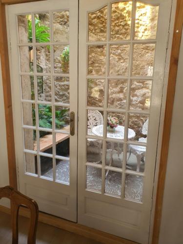 a white door with glass panels at Gite Sérénité in Magnac-Laval