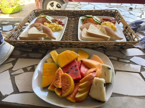 two plates of food with fruit on a table at Desired View in Choiseul