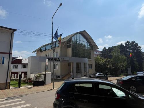 a black car parked in front of a building at Hotel Maria in Rădăuţi