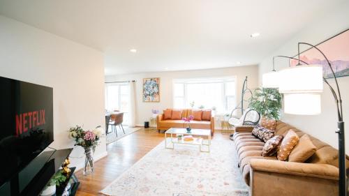 a living room with a couch and a table at Gorgeous 7BR 3BA Family Home in Maryland in Oxon Hill