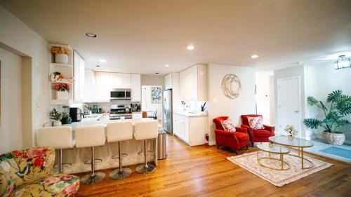 a kitchen and living room with a table and chairs at Gorgeous 7BR 3BA Family Home in Maryland in Oxon Hill