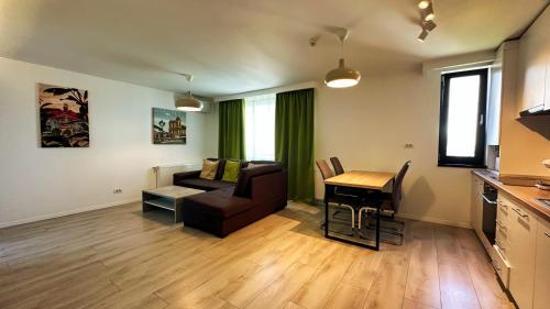 a living room with a couch and a table at Timisoara Prime Residence - powered by NEO - private parking in Timişoara