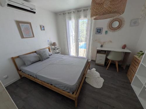a bedroom with a bed and a desk in it at Beautiful Provencal villa in Les Adrets de l'Esterel
