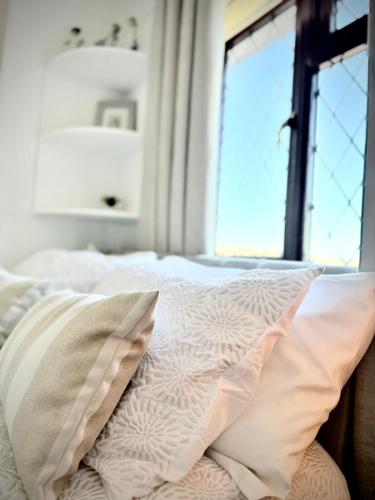 a bedroom with a bed with pillows and a window at 6 Bedroom 4 bathroom House 14 guests or more in Birmingham, Wolverhampton, Walsall Contractors, Family & Groups in Walsall