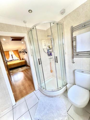 a bathroom with a shower and a toilet at 6 Bedroom 4 bathroom House 14 guests or more in Birmingham, Wolverhampton, Walsall Contractors, Family & Groups in Walsall