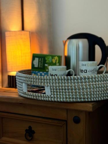 a white basket sitting on top of a dresser at 6 Bedroom 4 bathroom House 14 guests or more in Birmingham, Wolverhampton, Walsall Contractors, Family & Groups in Walsall