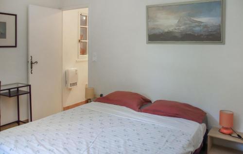 a bedroom with a bed with a painting on the wall at Mas Melusine in Caderousse
