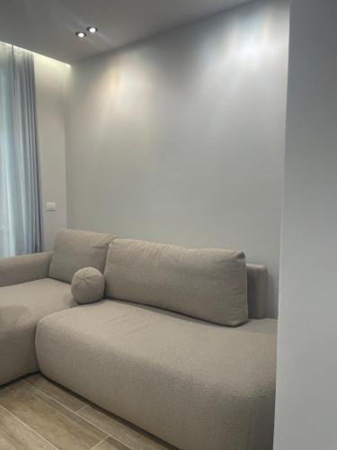 a couch in a room with a white wall at SanPietro Premium 224 in Lalzit Bay